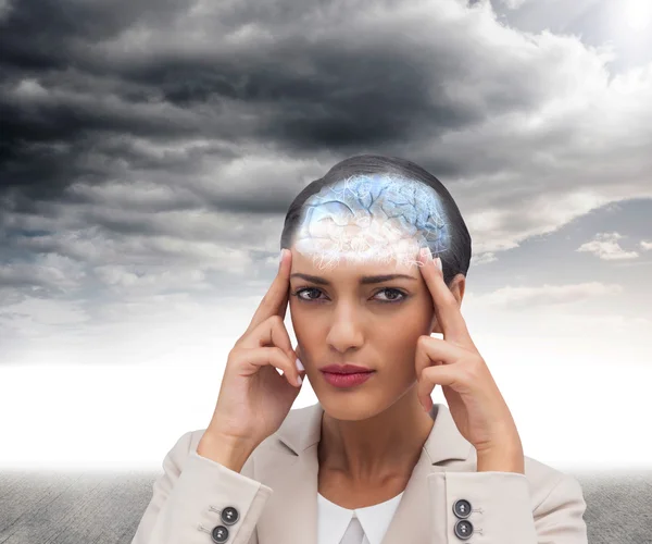 Businesswoman putting fingers on temples — Stock Photo, Image