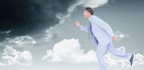 Stepping businessman against sky — Stock Photo, Image