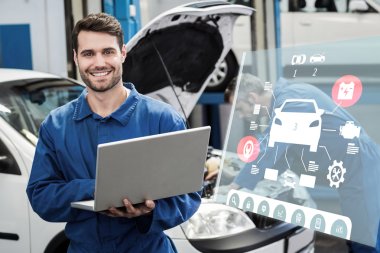 smiling mechanic using a laptop clipart