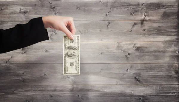 Businesswomans hand holding hundred dollar bill — Stock Photo, Image