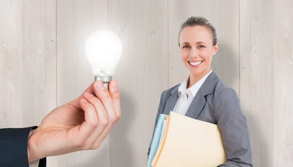 Light bulb and smiling businesswoman — Stock Photo, Image
