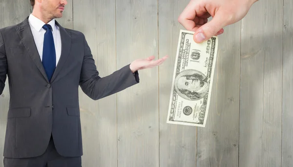 Affärsman med hans händer dollar bill — Stockfoto