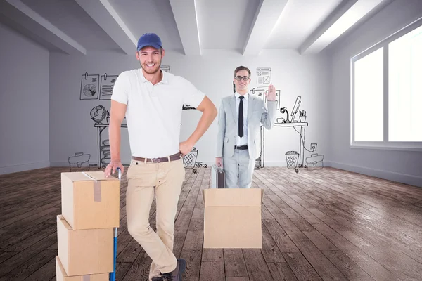 Delivery man leaning on trolley of boxes — Stock Photo, Image