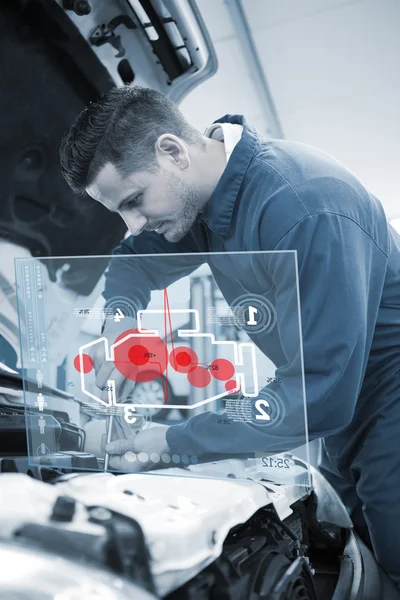 Mechanic using screwdriver on engine — Stock Photo, Image