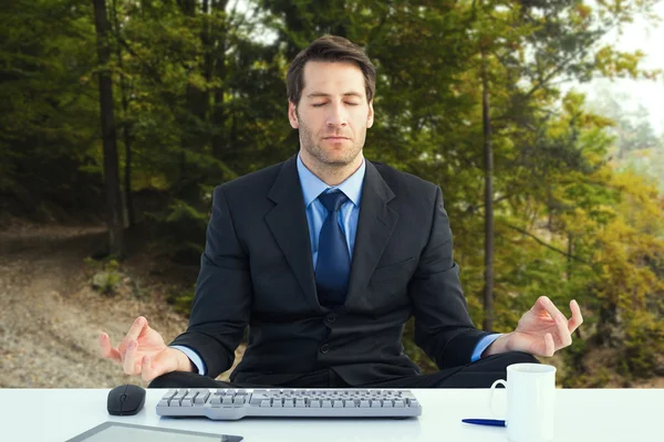 Businessman sitting in lotus pose — Stock Photo, Image