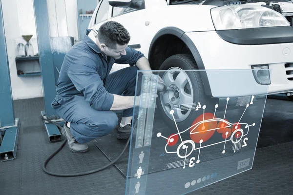 Mechanic adjusting the tire wheel — Stock Photo, Image