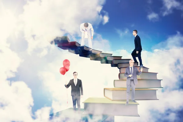 Businessmen on book stairs — Stock Photo, Image