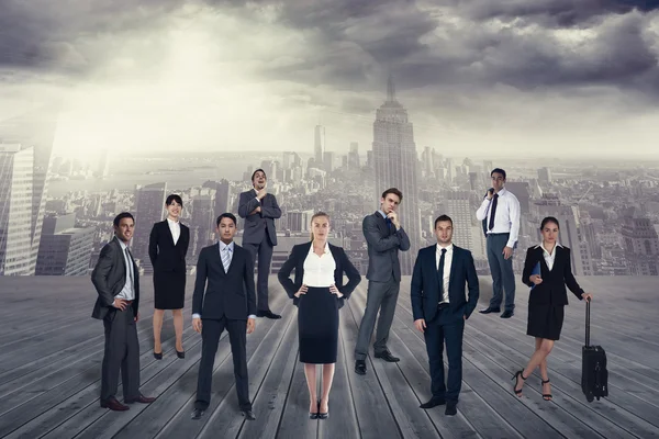 Business team against balcony overlooking city — Stock Photo, Image