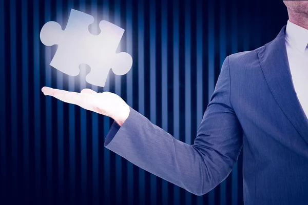 Businessman with puzzle piece — Stock Photo, Image