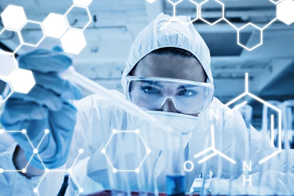 Student dropping liquid in test tube — Stock Photo, Image