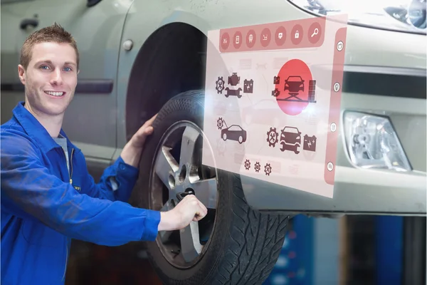 Auto mechanic changing car tire — Stock Photo, Image