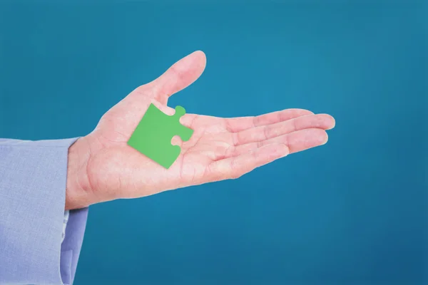 Handsome businessman with jigsaw piece — Stock Photo, Image