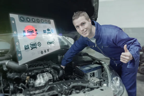 Mechanic under car bonnet gesturing thumbs up — Stock Photo, Image