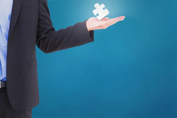 Businessman holding jigsaw piece — Stock Photo, Image
