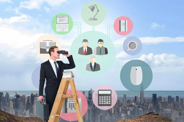 Businessman looking on a ladder — Stock Photo, Image
