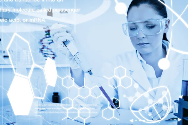 Redhaired scientist using a pipette — Stock Photo, Image