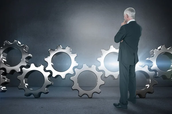 Thoughtful businessman standing back to camera — Stock Photo, Image