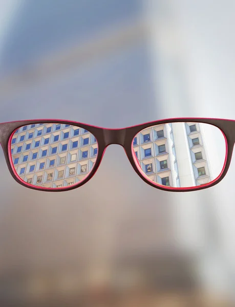 Composite image of glasses against skyscraper — Stock Photo, Image