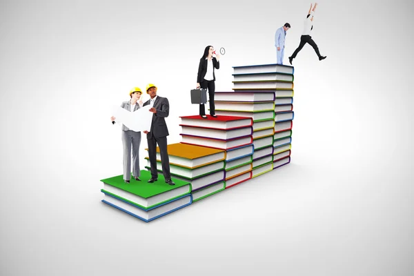 Businesspeople standing on books — Stock Photo, Image