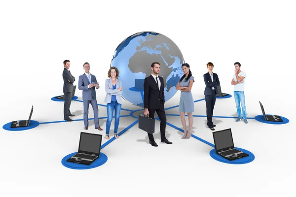 Business team against laptops connected with earth — Stock Photo, Image