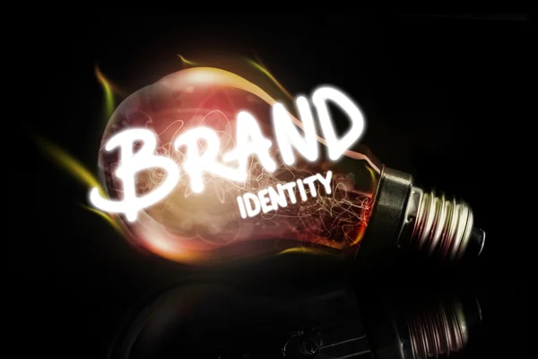 Brand identity against glowing light bulb — Stock Photo, Image