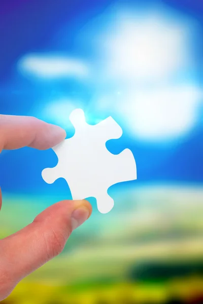 Hand holding jigsaw piece — Stock Photo, Image