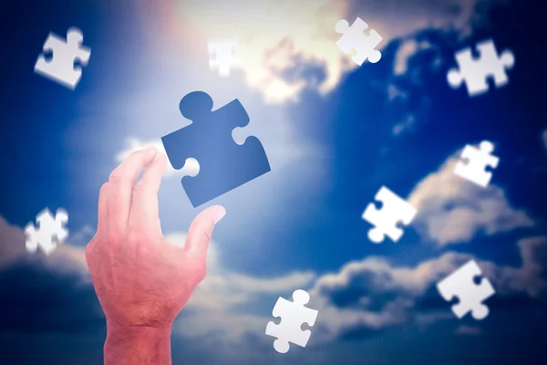 Hand presenting jigsaw piece — Stock Photo, Image