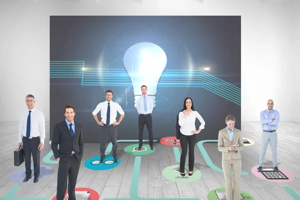 Business team against light bulb — Stock Photo, Image