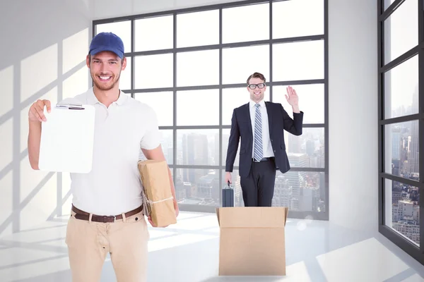 Delivery man holding cardboard box — Stock Photo, Image