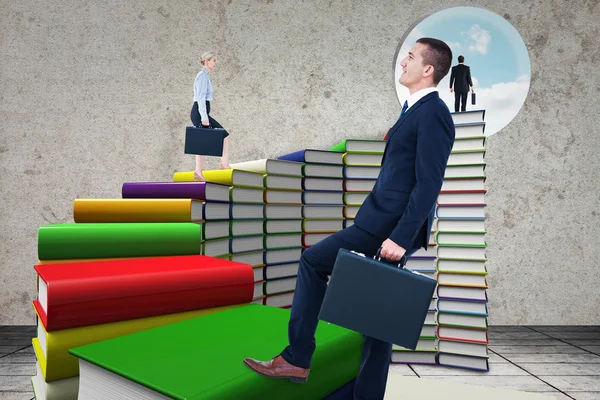 businesspeople walking on book stairs