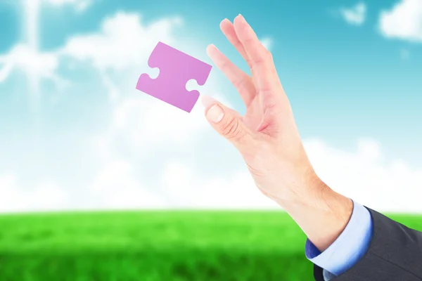 Businesswoman showing jigsaw piece — Stock Photo, Image