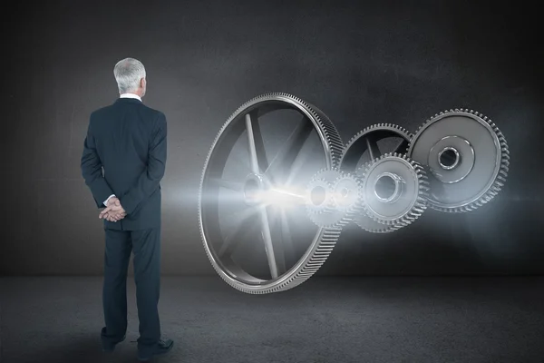 Businessman posing against black wall — Stock Photo, Image