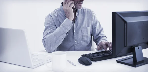 Businessman with cellphone, laptop and computer — Stock Photo, Image