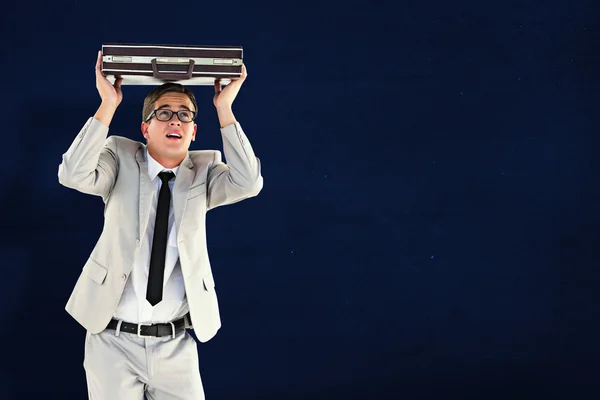 Businessman sheltering with briefcase — Stock Photo, Image