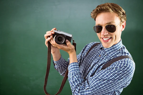 Hipster holding a retro camera — Stock Photo, Image