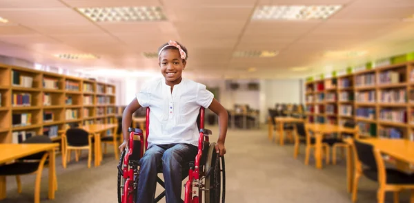 Girl sitting in wheelchair in school corridor — Stock Photo, Image