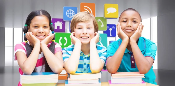 Cute pupils looking at camera in library — Stock Photo, Image