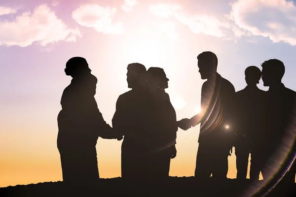 Silhouetten von Menschen beim Händeschütteln — Stockfoto