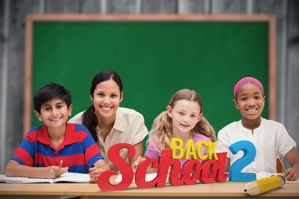 Teacher helping pupils in library — Stock Photo, Image