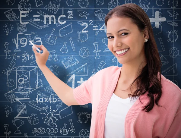 Brunette smiling and writing — Stock Photo, Image