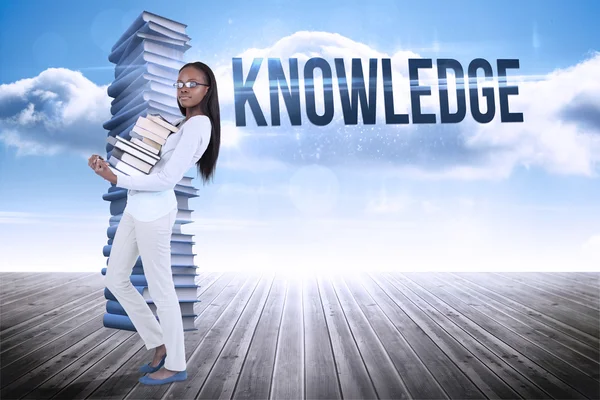 Word knowledge and woman carrying of books — Stock Photo, Image