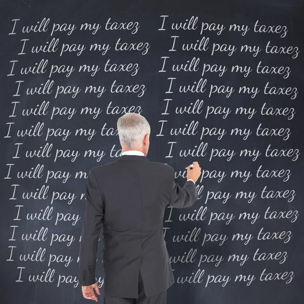 Businessman standing and writing — Stock Photo, Image