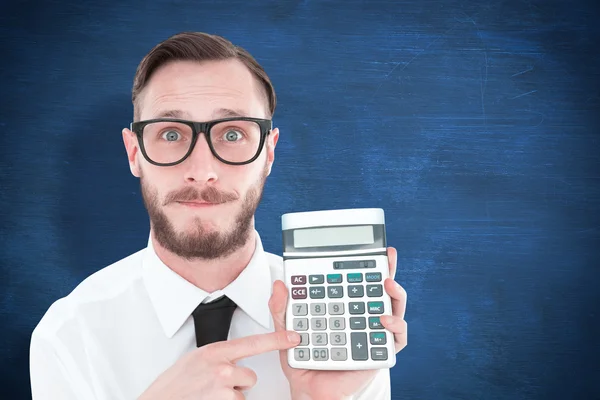 Geeky businessman pointing to calculator — Stock Photo, Image