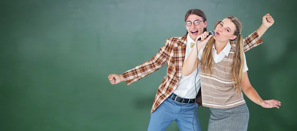 Geeky hipsters singing with microphone — Stock Photo, Image