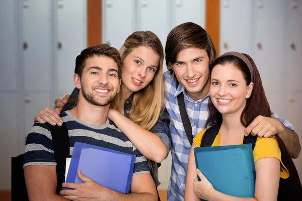 Students holding folders at college corridor — Stock Photo, Image