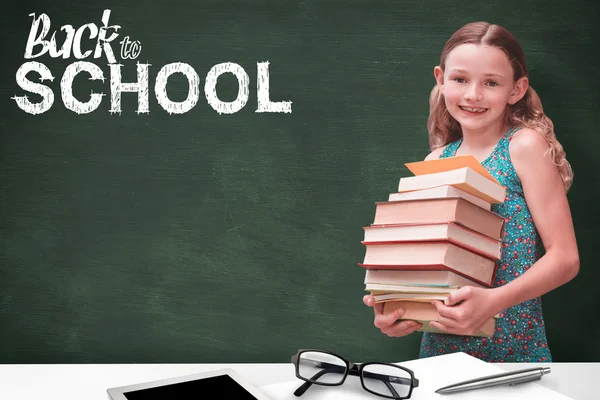 Girl carrying books in library — Stock Photo, Image