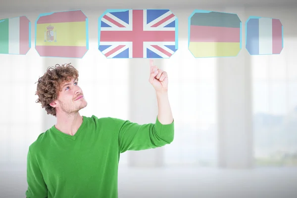 Man smiling while pointing upward — Stock Photo, Image