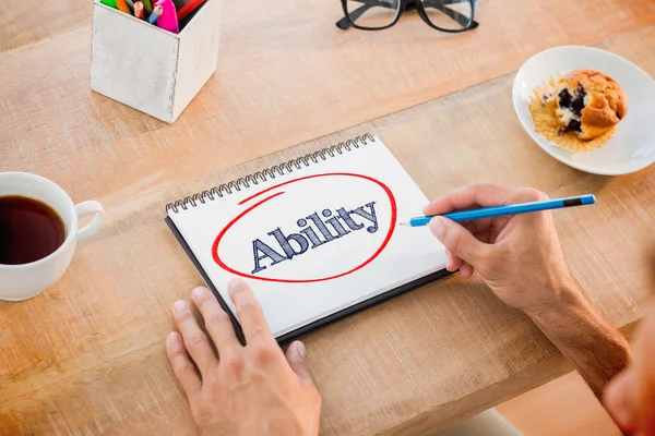 Testing against man writing notes on notebook — Stock Photo, Image