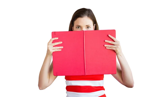 Student holding book over face — Stock Photo, Image