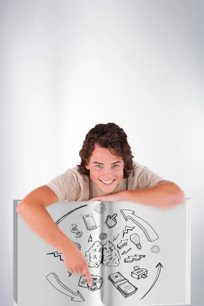 Young man showing a book — Stock Photo, Image